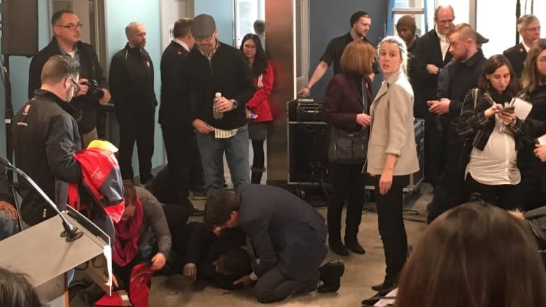 Ontario health minister helps homeless man who fainted during announcement on health care in shelters