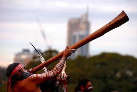 An Australian Aboriginal man plays a didgeridoo during a welcoming ceremony at Government House in Sydney, Australia, June 28, 2017. REUTERS/David Gray