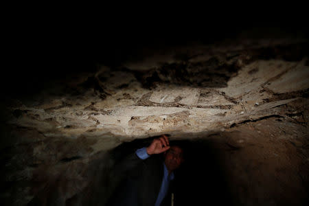 Archaeologist Musab Mohammed Jassim shows artefacts and archaeological pieces in a tunnel network running under the Mosque of Prophet Jonah, Nabi Yunus in Arabic, in eastern Mosul, Iraq March 9, 2017. Picture taken March 9, 2017. REUTERS/Suhaib Salem