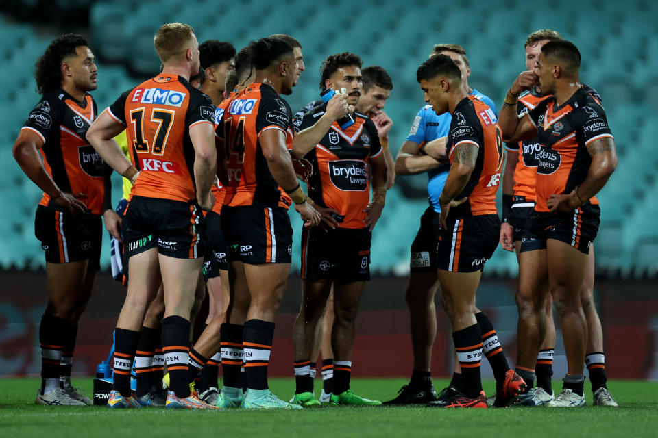 Seen here, West Tigers players look sad after a 66-point thrashing by the Roosters at the SCG.