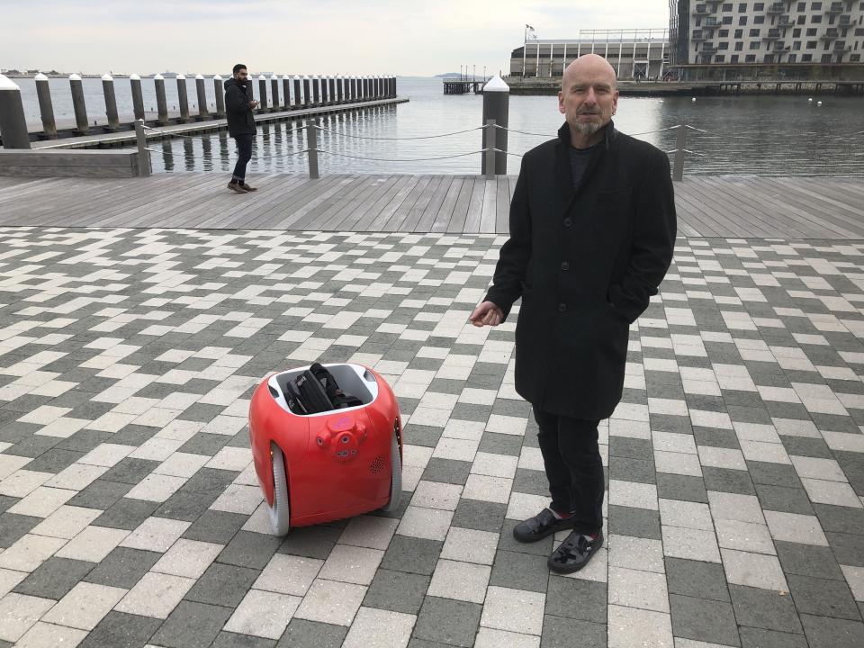 Piaggio Fast Forward co-founder Jeffrey Schnapp talks about his company's cargo-carrying robot called the Gita on Monday, Nov. 11, 2019, in Boston. The machine uses cameras and sensors to follow its owner carrying groceries and other items. (AP Photo/Matt O'Brien)