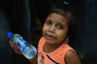 MUMBAI, MAHARASHTRA, INDIA - 2020/05/13: A girl cries as they wait to board vehicles during the lockdown. Due to lockdown situation, most migrants are stuck in Mumbai, some walk and others arrange their own trucks and buses to their home towns, while the police say that the buses are available by the government. (Photo by Ratika More/SOPA Images/LightRocket via Getty Images)