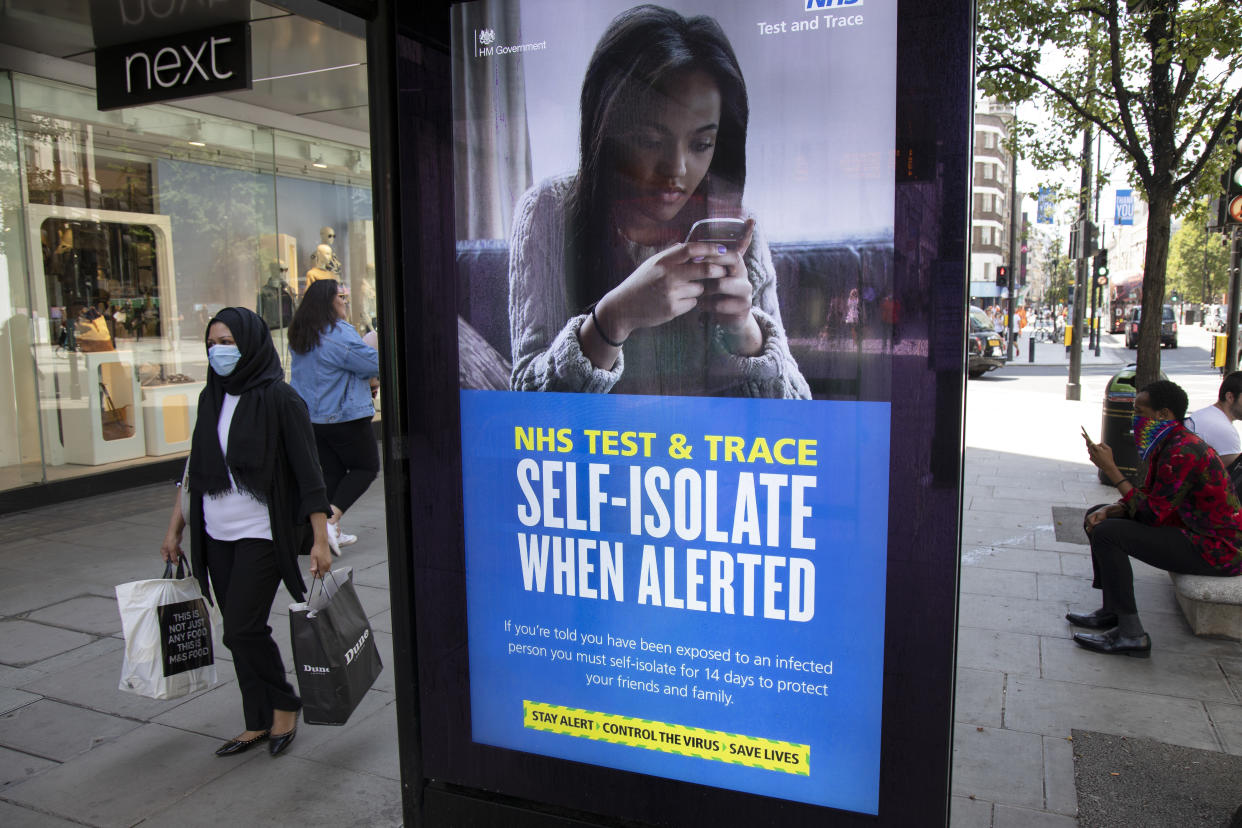 HM Government, Public Health England, NHS advertising boards advice to stay alert to the symptoms as part of the test and trace program as the Coronavirus lockdown measures are set to ease further, the west end starts to fill with people as they return to the shopping district on Oxford Street and the quiet city starts coming to an end on 22nd June 2020 in London, England, United Kingdom. As of today the government has relaxed it's lockdown rules, and is allowing some non-essential shops to open with individual shops setting up 'social distancing' queueing systems. (photo by Mike Kemp/In PIctures via Getty Images)