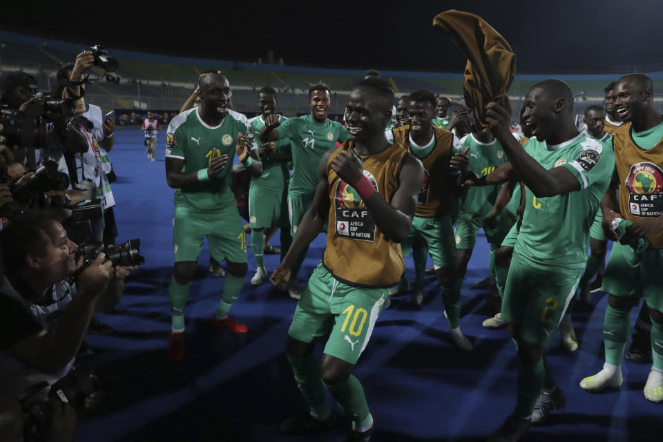 Senegal's Sadio Mane, center, celebrates end of the African Cup of Nations semifinal soccer match between Senegal and Tunisia in 30 June stadium in Cairo, Egypt, Sunday, July 14, 2019. (AP Photo/Hassan Ammar)