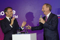 French President Emmanuel Macron, left, applauds Microsoft CEO Brad Smith at the French Microsoft headquarters in Issy-les-Moulineaux, outside Paris, Monday, May 13, 2024. Microsoft, which has been present in France for 41 years, is announcing a 4 billion euro investment this year, the largest to date in the country, to support French growth in the new artificial intelligence economy. (AP Photo/Thibault Camus, Pool)