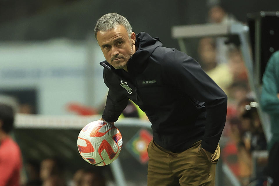 FILE - Spain's head coach Luis Enrique holds the ball during the UEFA Nations League soccer match between Portugal and Spain at the Municipal Stadium in Braga, Portugal, Tuesday, Sept. 27, 2022. (AP Photo/Luis Vieira, File)