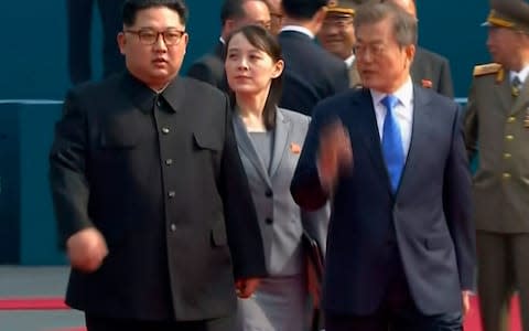 North Korean leader Kim Jong Un, left, walks with South Korean President Moon Jae-in and his sister Kim Yo Jong  - Credit: AP