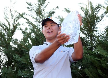 May 14, 2017; Ponte Vedra Beach, FL, USA; Si Woo Kim hoist the trophy after winning The Players Championship golf tournament at TPC Sawgrass - Stadium Course. Mandatory Credit: Peter Casey-USA TODAY Sports