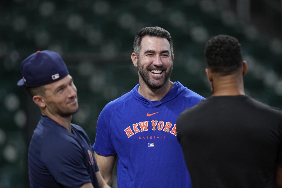 New York Mets pitcher Justin Verlander, center, talks with Houston Astros' Alex Bregman, left, and Michael Brantley, right, before a baseball game Monday, June 19, 2023, in Houston. (AP Photo/David J. Phillip)