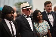 Sri Lankan actor Jesuthasan Antonythasan, French director Jacques Audiard and Sri Lankan actress Kalieaswari Srinivasan as they arrive for the Cannes closing ceremony