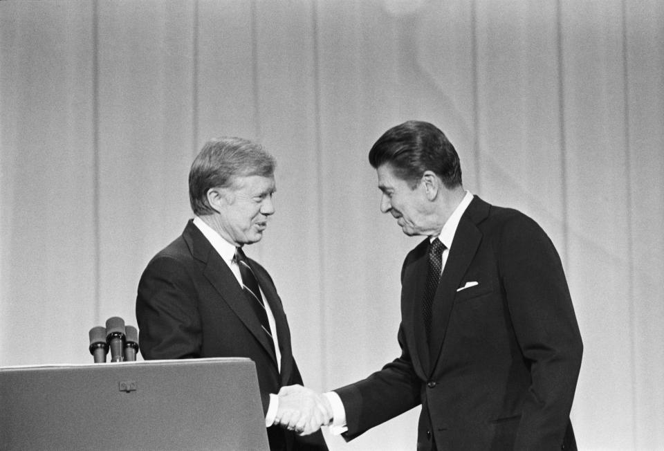 President Jimmy Carter and his Republican challenger, Ronald Reagan, shake hands as they greet one another before their debate on the stage of the Music Hall in Cleveland, Ohio. | Bettmann—Bettmann Archive
