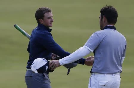 Paul Dunne of Ireland (L) shakes hands with Louis Oosthuizen of South Africa on the 18th green during the third round of the British Open golf championship on the Old Course in St. Andrews, Scotland, July 19, 2015. REUTERS/Russell Cheyne -