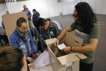 Electoral officials count ballots after tables closed during the seven-question referendum on anti-corruption measures in Bogota, Colombia August 26, 2018. REUTERS/Luisa Gonzalez