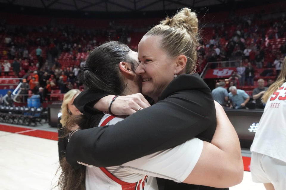 Utah coach Lynne Roberts hugs Alissa Pili following the team's second-round college basketball game against Princeton in the women's NCAA Tournament, Sunday, March 19, 2023, in Salt Lake City. (AP Photo/Rick Bowmer)