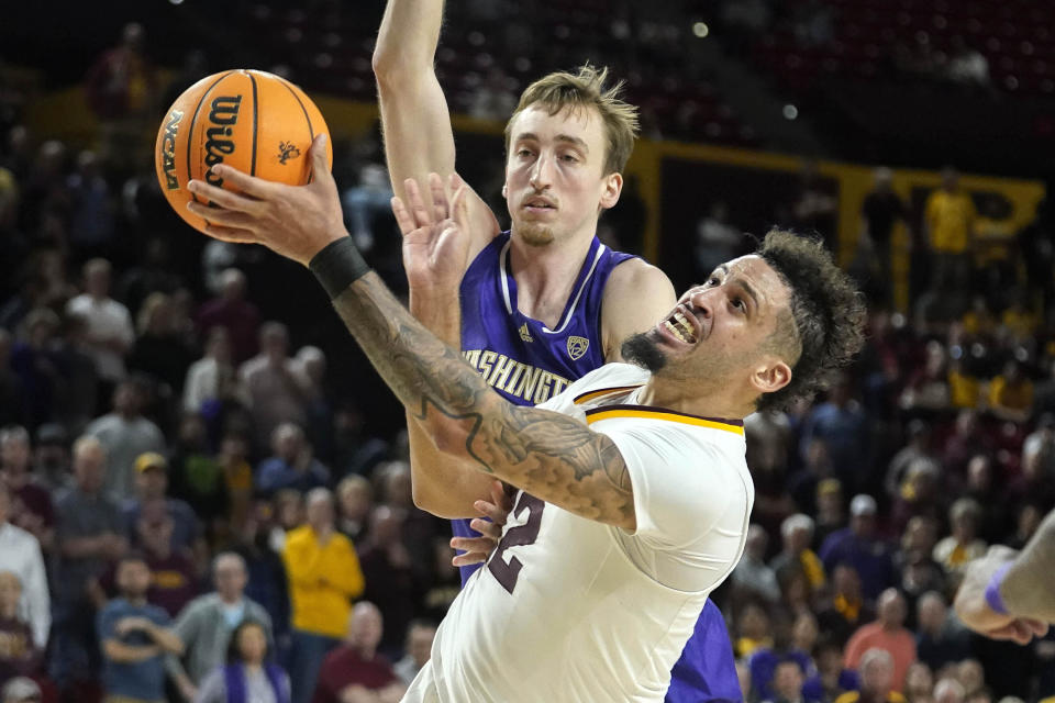 Arizona State guard Jose Perez (12) gets fouled by Washington forward Moses Wood (13) during the second half of an NCAA college basketball game Thursday, Feb. 22, 2024, in Tempe, Ariz. (AP Photo/Darryl Webb)