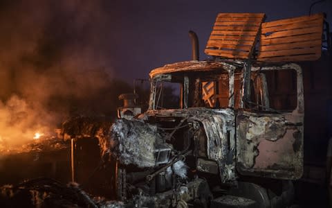 A burnt truck previously loaded with humanitarian aid sits on the Francisco De Paula Santander International Bridge near the border with Venezuela in Cucuta - Credit: Bloomberg