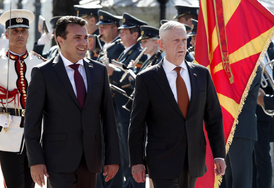 U.S. Defense Secretary James Mattis, right, accompanied by Macedonian Prime Minister Zoran Zaev, left, walks past an honor guard squad upon his arrival at the government building in Skopje, Macedonia, Monday, Sept. 17, 2018. Mattis arrived in Macedonia Monday, condemning Russian efforts to use its money and influence to build opposition to an upcoming vote that could pave the way for the country to join NATO, a move Moscow opposes. (AP Photo/Boris Grdanoski)