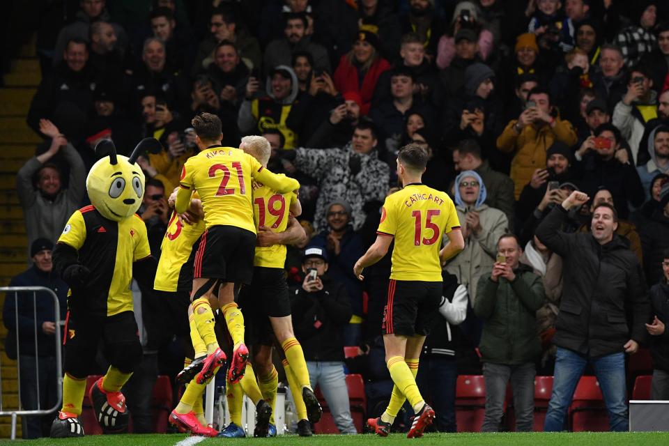 Watford's English striker Troy Deeney celebrates with teammates after scoring his team's third goal during the English Premier League football match between Watford and Liverpool at Vicarage Road Stadium in Watford, north of London on February 29, 2020. (Photo by Justin TALLIS / AFP) / RESTRICTED TO EDITORIAL USE. No use with unauthorized audio, video, data, fixture lists, club/league logos or 'live' services. Online in-match use limited to 120 images. An additional 40 images may be used in extra time. No video emulation. Social media in-match use limited to 120 images. An additional 40 images may be used in extra time. No use in betting publications, games or single club/league/player publications. /  (Photo by JUSTIN TALLIS/AFP via Getty Images)
