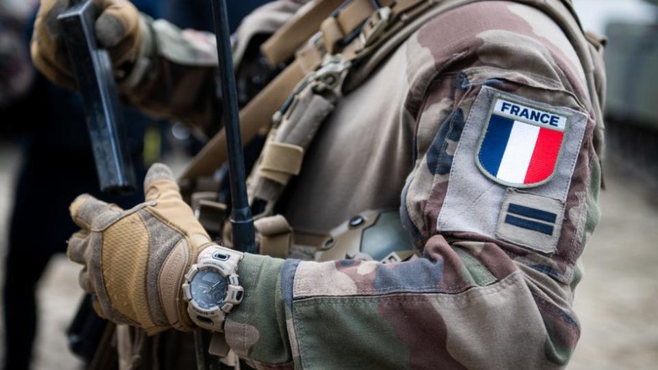 A soldier with a French flag badge on his uniform