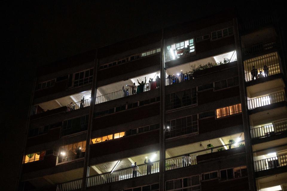 Residents of a building across the "20 de Noviembre" hospital sing and wave lights to praise medical staff and patients in Mexico City, on April 28, 2020, amid the novel coronavirus pandemic. - Latin America is like "Europe six weeks ago" in relation to the advance of COVID-19, so an increase in the number of cases is expected in the coming weeks, warned on April 28 the deputy director of the Pan American Health Organization (PAHO), Jarbas Barbosa. (Photo by PEDRO PARDO / AFP) (Photo by PEDRO PARDO/AFP via Getty Images)