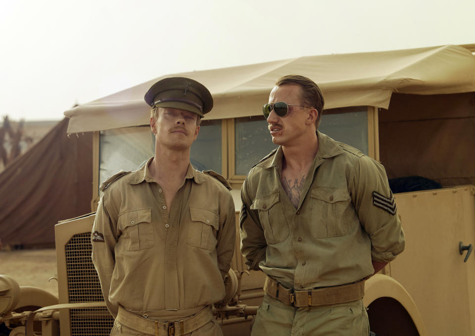 This image released by Epix shows Alfie Allen, left, and Theo Barklem-Biggs in a scene from "Rogue Heroes." The series, about the origin of Britain’s elite Special Air Service, premieres Nov. 13 on Epix. (Epix via AP)