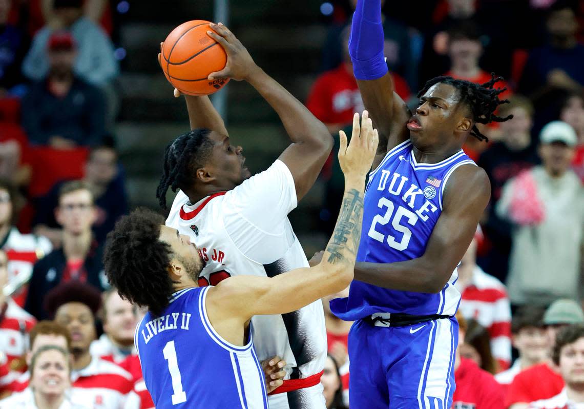 Duke’s Dereck Lively II (1) and Mark Mitchell (25) defend N.C. State’s D.J. Burns Jr. (30) during the first half of N.C. State’s game against Duke at PNC Arena in Raleigh, N.C., Wednesday, Jan. 4, 2023.