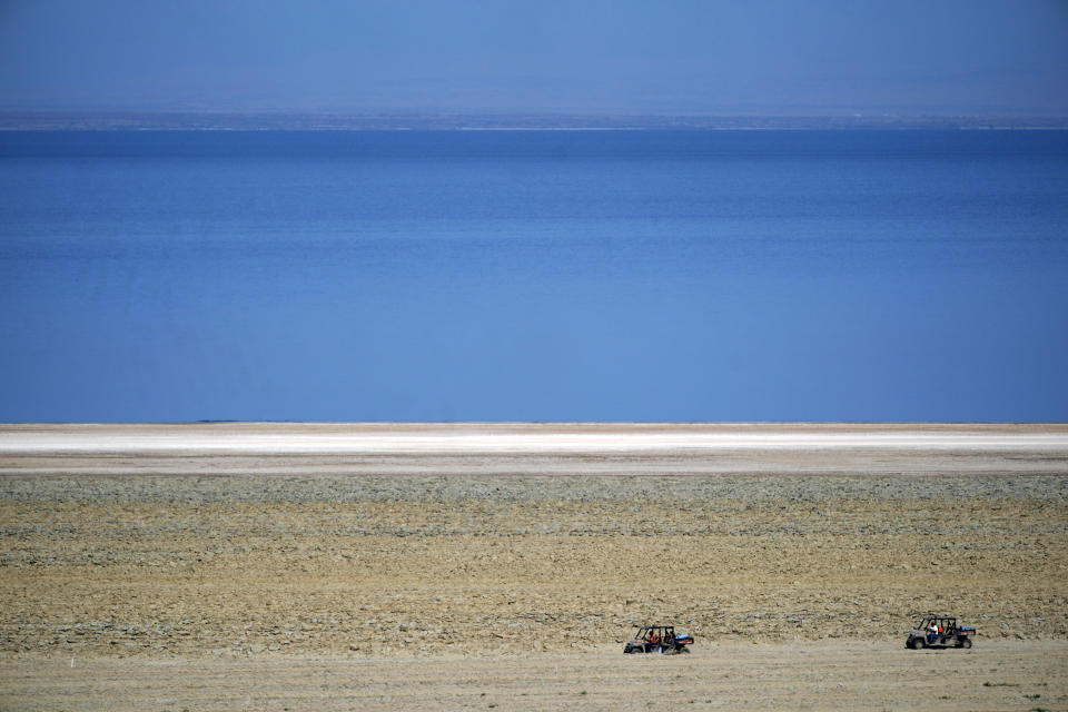 Off-road vehicles are driven on the property owned by Controlled Thermal Resources, which will be mined for lithium along the Salton Sea, in Niland, Calif., Thursday, July 15, 2021. Demand for electric vehicles has shifted investments into high gear to extract lithium from geothermal wastewater around California's dying Salton Sea. The ultralight metal is critical to rechargeable batteries. (AP Photo/Marcio Jose Sanchez)