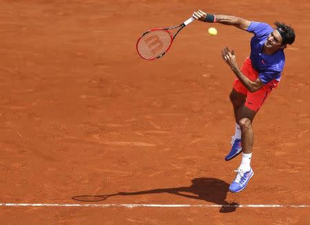 Roger Federer of Switzerland plays a shot to Marcel Granollers of Spain during their men's singles match at the French Open tennis tournament at the Roland Garros stadium in Paris, France, May 27, 2015. REUTERS/Vincent Kessler