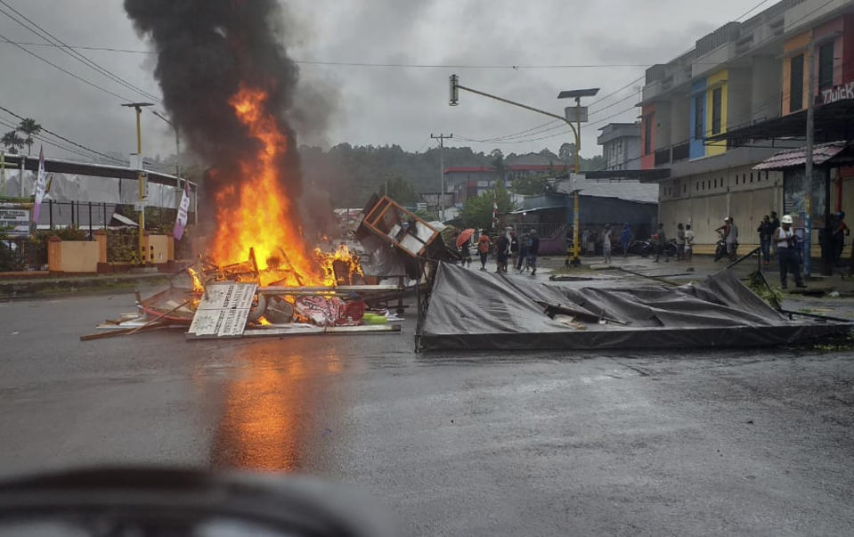 Fires burn during a violent protest in Manokwari, Papua province, Indonesia, Monday, Aug. 19, 2019. The protest was sparked by accusations that Indonesian police who backed by the military, have arrested and insulted dozens of Papuan students in their dormitory in East Java's cities of Surabaya and Malang a day earlier. (AP Photo/Safwan Ashari Raharusun)