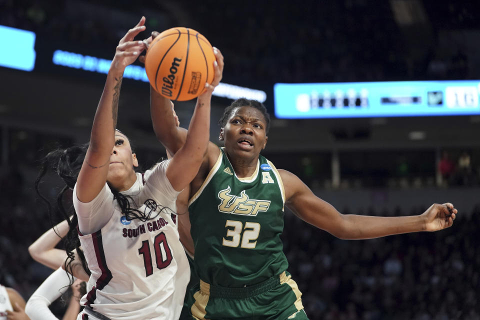 South Florida forward Dulcy Fankam Mendjiadeu (32) and South Carolina center Kamilla Cardoso (10) battles for a rebound during the first half in a second-round college basketball game in the NCAA Tournament, Sunday, March 19, 2023, in Columbia, S.C. (AP Photo/Sean Rayford)