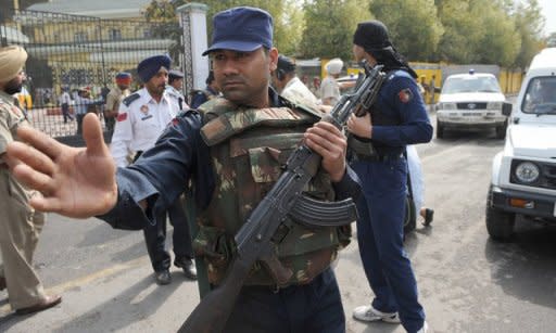 An Indian commando escorting the Pakistan team bus gestures outside the Punjab Cricket Associaton (PCA) stadium in Mohali. With their World Cup semi-final hailed as a diplomatic game-changer, as well as the mother of all cricket battles, India and Pakistan were just desperate to get the game underway