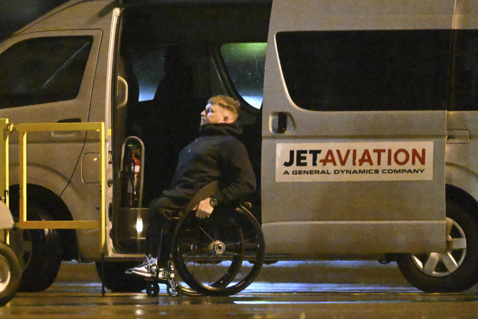 Retired champion tennis player Dylan Alcott prepares to board a Royal Australian Air Force aircraft at Sydney Airport, in Sydney, Thursday, Sept. 15, 2022, before taking off for London. Australia said it is helping officials from Solomon Islands, Papua New Guinea, Tuvalu, Samoa and a fifth unnamed British Commonwealth nation in the Oceania region travel to London for Queen Elizabeth II's funeral. (Dean Lewins/AAP Image via AP)