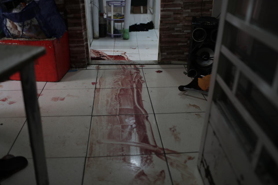 Blood covers the floor of a home during a police operation targeting drug traffickers in the Jacarezinho favela of Rio de Janeiro, Brazil, Thursday, May 6, 2021. At least 25 people died including one police officer and 24 suspects, according to the press office of Rio's civil police. (AP Photo/Silvia Izquierdo)
