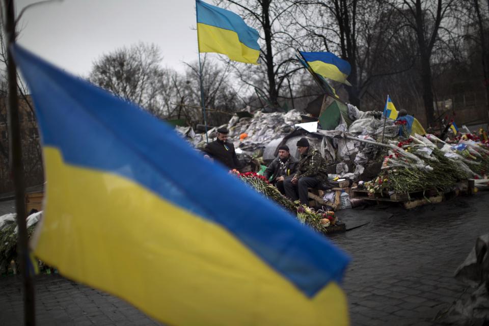 Anti-Yanukovych protesters guard a barricade on a street heading to Kiev's Independence Square, in Ukraine, Wednesday, March 5, 2014. Stepping back from the brink of war, Vladimir Putin talked tough but cooled tensions in the Ukraine crisis Tuesday, saying Russia has no intention "to fight the Ukrainian people" but reserves the right to use force. As the Russian president held court in his personal residence, U.S. Secretary of State John Kerry met with Kiev's fledgling government and urged Putin to stand down. (AP Photo/Emilio Morenatti)