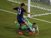 Japan's Yoshito Okubo (L) tries to steal the ball away from Greece's Orestis Karnezis during their 2014 World Cup Group C soccer match at the Dunas arena in Natal June 19, 2014. REUTERS/Carlos Barria