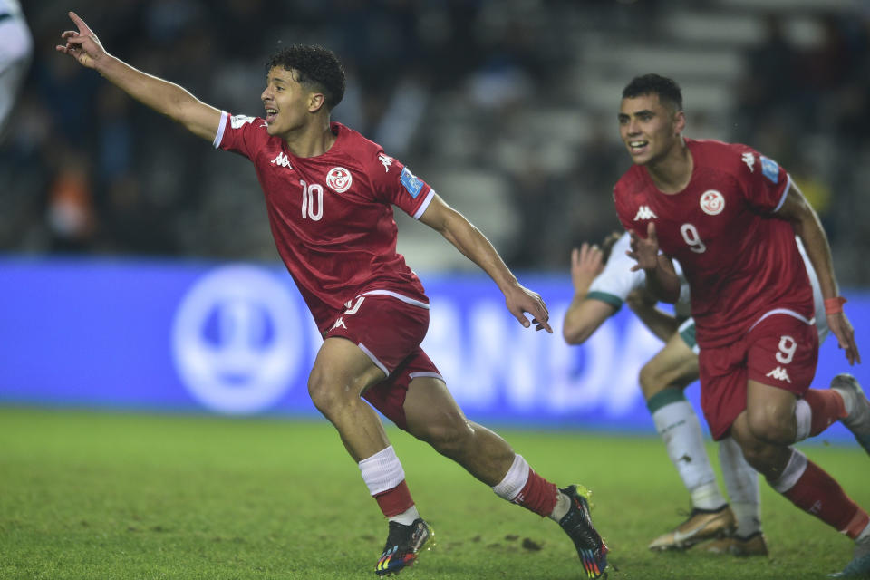 Tunisia's Chaim El Djebali, left, celebrates scoring his side's second goal during a FIFA U-20 World Cup Group E soccer match against Iraq at Diego Maradona stadium in La Plata, Argentina, Thursday, May 25, 2023. (AP Photo/Gustavo Garello)