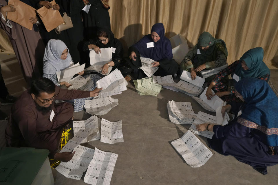 Members of polling staff count the votes after the polls closed for parliamentary elections, in Karachi, Pakistan, Thursday, Feb. 8, 2024. (AP Photo/Fareed Khan)