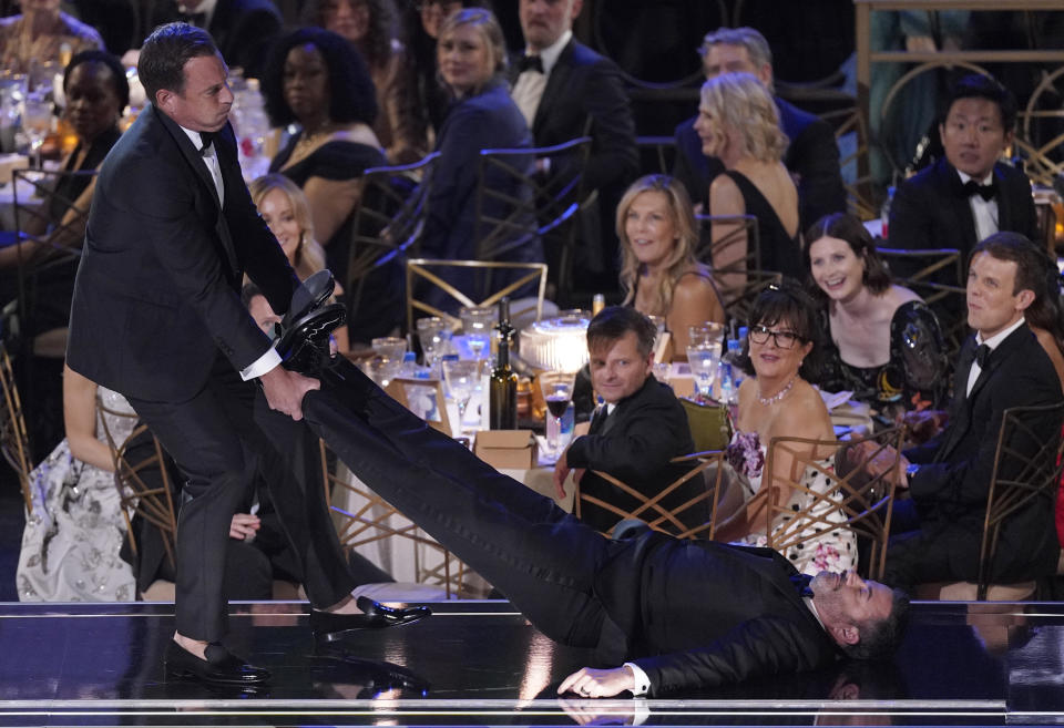 Will Arnett, left, drags Jimmy Kimmel onstage to present the Emmy for outstanding writing for a comedy series at the 74th Primetime Emmy Awards on Monday, Sept. 12, 2022, at the Microsoft Theater in Los Angeles. (AP Photo/Mark Terrill)