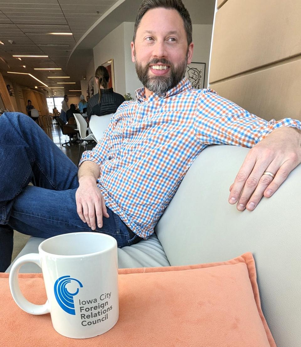 Executive Director Peter Gerlach is shown at Fix! coffee shop in Iowa City along with a special traditional mug presented to guest speakers for the Iowa City Foreign Relations Council, now finishing it’s 40th anniversary year.