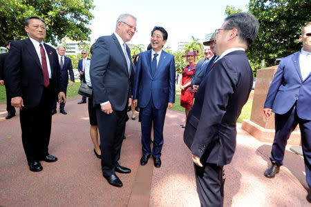 Japanese Prime Minister Shinzo Abe is greeted by Australian Prime Minister Scott Morrison at the Cenotaph in Darwin, Australia November 16, 2018. REUTERS/Glenn Campbell