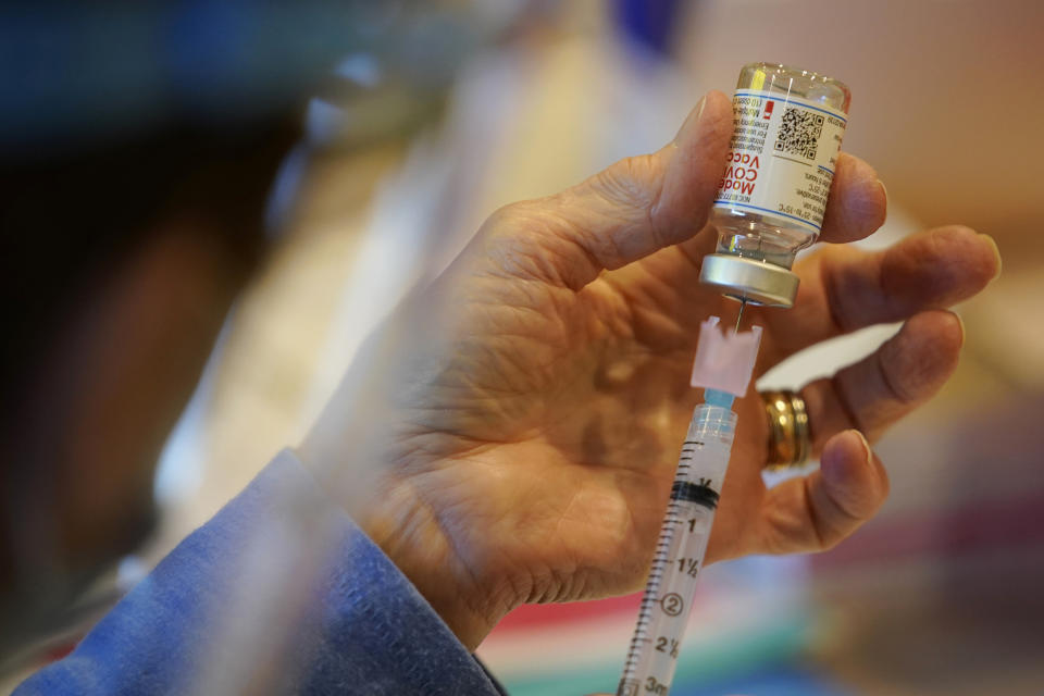 FILE - In this Dec. 29, 2020, file photo, Pat Moore, with the Chester County, Pa., Health Department, fills a syringe with Moderna COVID-19 vaccine before administering it to emergency medical workers and health care personnel at the Chester County Government Services Center in West Chester, Pa. On Friday, May 21, The Associated Press reported on stories circulating online incorrectly claiming SM-102 is an ingredient in the Moderna vaccine that is not safe for humans or veterinary use. (AP Photo/Matt Slocum, File)