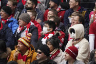 A fan wearing a protective mask attends at the English Premier League soccer match between Liverpool and Bournemouth at Anfield stadium in Liverpool, England, Saturday, March 7, 2020. (AP Photo/Jon Super)