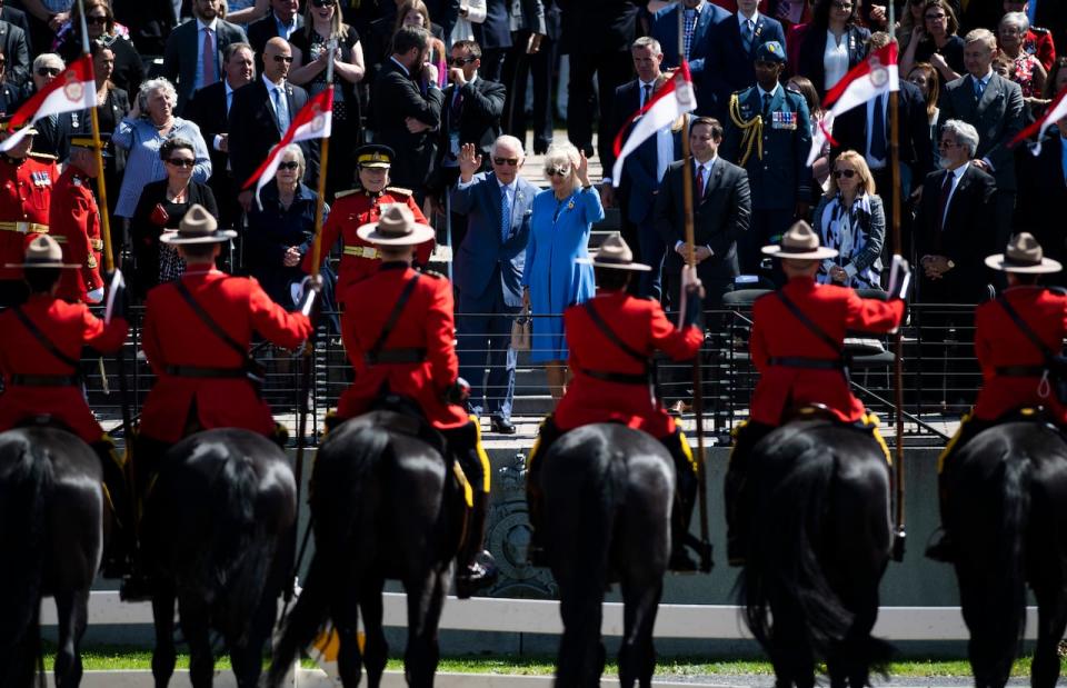 Prince Charles and Camilla, Duchess of Cornwall wave after a performance of the RCMP Musical Ride in Ottawa, during their Canadian Royal tour, on Wednesday, May 18, 2022. 