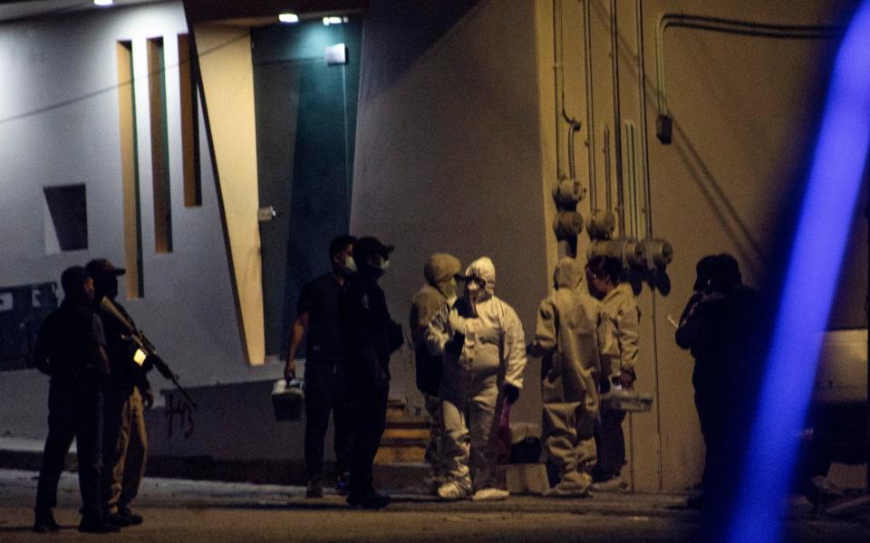 Investigators and forensic teams at the scene where the remains of Arcos were found on Oct 6