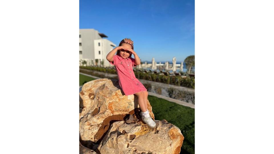 Ella Jordan daughter of James Jordan posing on a rock 