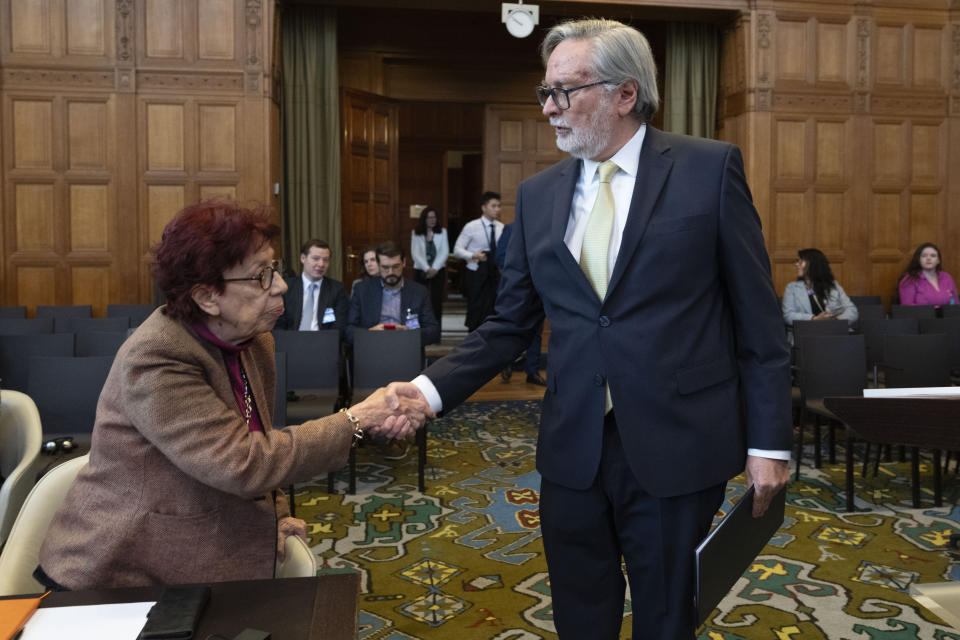 Ecuador's ambassador Andres Teran Parral, right, greets Mexico's agent and ambassador Carmen Moreno Toscano, left, at the International Court of Justice, or World Court, in The Hague, Netherlands, Wednesday, May 1, 2024. Mexico is taking Ecuador to the United Nations' top court on Tuesday accusing the nation of violating international law by storming into the Mexican embassy in Quito on April 5, and arresting former Ecuador Vice President Jorge Glas, who had been holed up there seeking asylum in Mexico. (AP Photo/Peter Dejong)