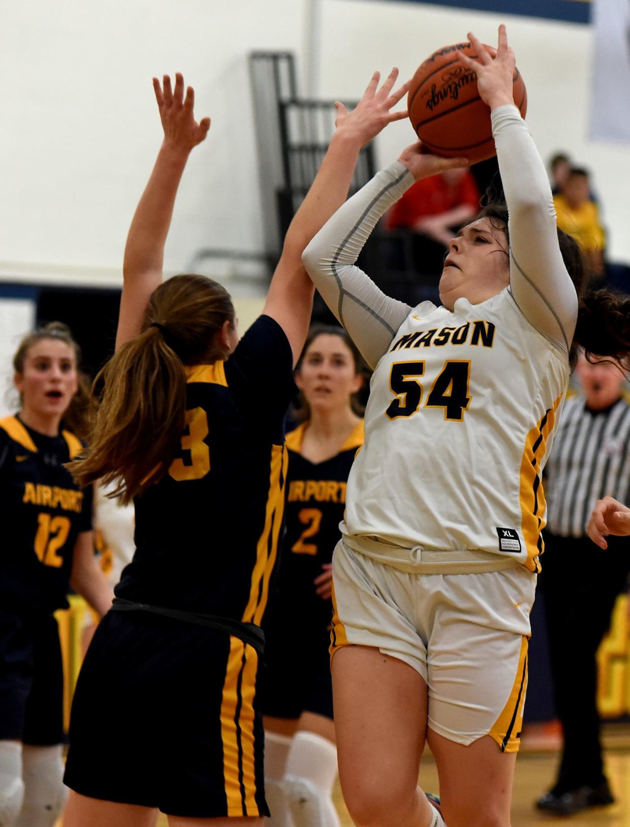 Monica DeGasto of Erie Mason shoots over Airport's Tara Szuper Tuesday night. DeGasto scored 16 points to help Mason earn a 53-35 win in the season opener for both teams.