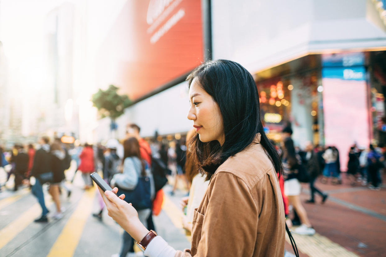 Young woman checking mobile phone. (PHOTO: Getty Images)