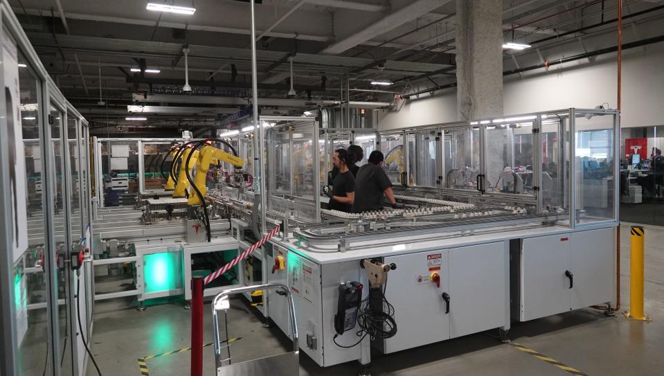 Panasonic employees assemble battery cells for Tesla electric vehicles at the companies' join factory in Nevada. Oklahoma tried to land Panasonic's second U.S. battery factory, but lost out to Kansas.