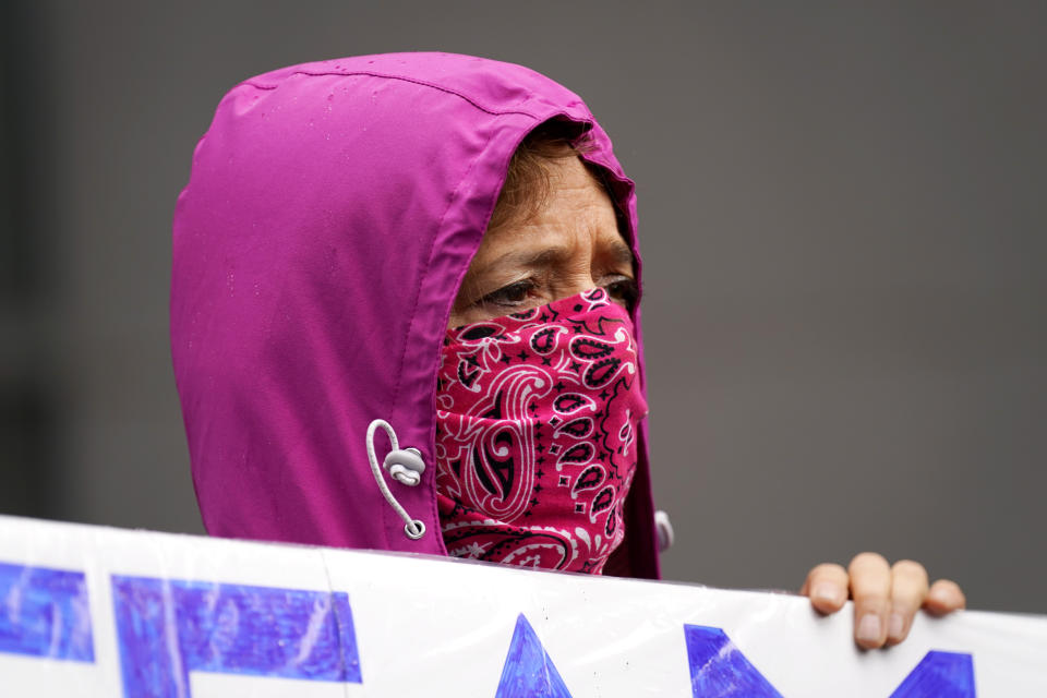 Mosie Boyd a supporter of Democratic presidential candidate, former Vice President Joe Biden, walks near the venue during the first day of the Republican National Convention on Monday, Aug. 24, 2020, in Charlotte, N.C. (AP Photo/Gerry Broome)